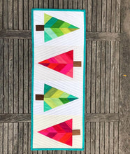 Load image into Gallery viewer, Festive Forest table runner and quilt block pattern by Penny Spool Quilts. Foundation paper pieced pattern. Image shows table runner in traditional christmas colours of red and green, on white background