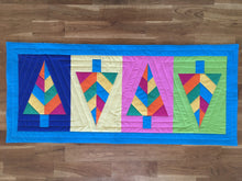 Load image into Gallery viewer, Festive Forest table runner and quilt block pattern by Penny Spool Quilts. Foundation paper pieced pattern. Image shows table runner in retro christmas colours of blue, orange, pink, green and yellow.