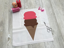 Load image into Gallery viewer, Ice Cream Cone quilt block pattern by Penny Spool Quilts. Part of the Ice Cream Sunday collection. Wafer cone with one scoop of chocolate ice cream and one scoop of pink ice cream, on white background. Shown with spools of thread, clips and small scissors on light grey wood flooring.
