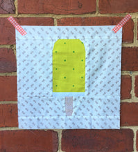 Load image into Gallery viewer, Ice Cream Bar 1 foundation paper pieced quilt block pattern by Penny Spool Quilts. Yellow ice cream bar on white patterned background.
