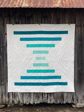 Load image into Gallery viewer, Raise the Bar quilt pattern by Penny Spool Quilts - Sample quilt in turquoise ombre and white on old barn wall

