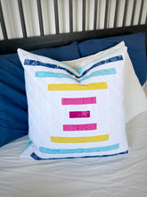 Load image into Gallery viewer, Raise the Bar quilt pattern by Penny Spool Quilts - Sample quilted pillow with blue, yellow and pink stripes on white
