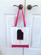 Load image into Gallery viewer, Ice Cream Bar 2 foundation paper pieced quilt block pattern by Penny Spool Quilts. Shows raspberry chocolate ice cream bar with bite out top corner, on white background fabric, made into a tote with matching pink bottom and handles.
