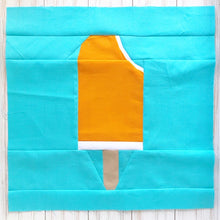 Load image into Gallery viewer, Ice Cream Bar 2 foundation paper pieced quilt block pattern by Penny Spool Quilts. Shows orange creamsicle with bite out top corner, on bright blue background fabric
